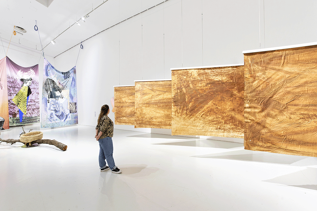 View of the exhibition Globalisto. A Philosophy in Flux at the Musée d’art moderne et contemporain de Saint-Étienne Métropole. From left: Porky Hefer, Appropriated objects, Arles I, 2022. Oak tree, wicker. Collection of the artist. Raphaël Barontini. Black Centurion, 2019, digital print and screen print on fabric. Private collection . Crowning, 2017. Digital print and silkscreen on fabric. Courtesy Galerie Mariane Ibrahim, Paris . Toussaint Louvertur[e], 2018. Digital print and screen print on fabric. Courtey Galerie Mariane Ibrahim, Paris. Moshekwa Langa, Drag paintings, 2016. Clay on canvas. Courtesy of the artist and Stevenson Gallery, Cape Town, South Africa. (Photo credit: C. Cauvet / MAMC+)