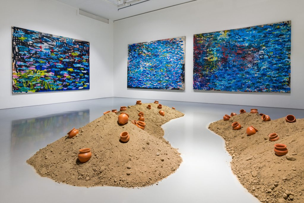 Installation view of Indigo Waves and Other Stories: Re-Navigating the Afrasian Sea and Notions of Diaspora, featuring surge (social cataracts), 2021 by Oscar Murillo and Vessel, 2020, by Sacintya Mohini Simpson with Isha Ram Das. Artworks: Oscar Murillo, courtesy of the artist. Sacintya Mohini Simpson with Isha Ram Das, courtesy of the artists and Milani Gallery, Brisbane. (© Courtesy of Zeitz MOCAA)